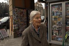 old woman at a magazine shop in Florence