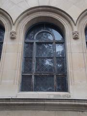 Arch window with stucco heads in Vajdahunyad Castle's Romanesque wing