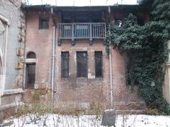 Brick facade with a corbel-supported balcony in the Romanesque wing of Vajdahunyad Castle