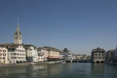 Panoramic view of Zürich with Lake Zurich, buildings, and mountains in the background