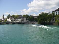 View from Mühlesteg bridge on Schipfe with St. Peter's Church tower, boat Felix on the water, and old orphanage on the right