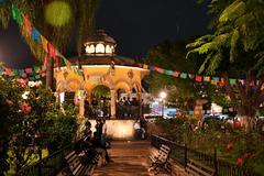 Jardín Hidalgo and bandstand at night with papel picado decorations for Day of the Dead in Tlaquepaque