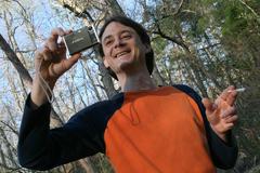 Man with Fujifilm Finepix camera and hand-rolled cigarette