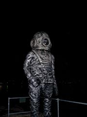 Aquanaut sculpture at night