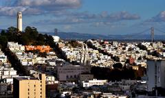 Coit Tower with Oakland Bay Bridge in the background