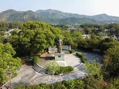 scenic view of Man Tin Cheung Park with pathways, greenery, and historic monument