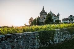 Vufflens Castle at sunset with vineyards