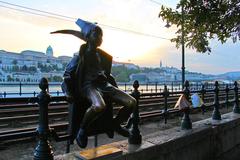 Little Princess statue sitting on the railings of the Danube promenade in Budapest