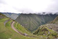 terraced hillside in Machu Picchu with mountains in the background