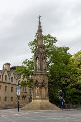 Historic stone building with an archway adorned with intricate carvings and sculptures