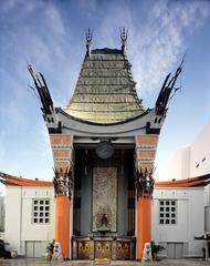 Grauman's Chinese Theatre with crowds inspecting handprints of movie stars