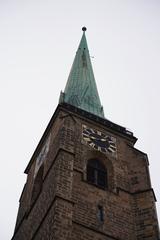 Church of St. Bartholomew with snowy mountain backdrop