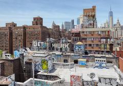 Rooftop graffiti at 47 Monroe Street seen from the Manhattan Bridge walkway