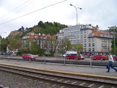 Tram stop Přístaviště on Modřanská street in Braník, Prague, Czech Republic, with Braník Rock in the background