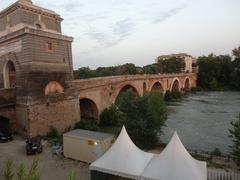 Ponte Milvio bridge with people walking and the river flowing underneath