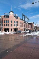 Coors Field stadium under a clear blue sky