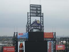 Coors Field scoreboard showing game details