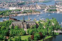 Djurgarden island with lush greenery and buildings along the waterfront