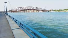 Atal Pedestrian Bridge over river with cityscape in the background