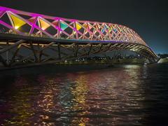 Sabarmati riverfront and Atal Pedestrian Bridge at night with colorful lighting