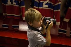 Boy with camera in front of the Hockey Hall of Fame