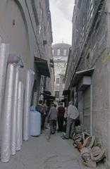 Rüstem Pasha Mosque elevated with shops and second-hand clothing sale in the alley