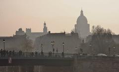 Pont Saint-Louis with silhouettes of Saint-Étienne-du-Mont church and Panthéon de Paris at dusk