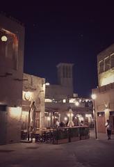 Al Seef heritage area with traditional buildings and a waterfront at sunset