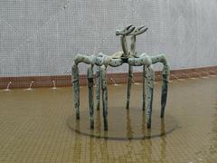 Bronze sculpture of Crab No. 1 at Salisbury Garden in Hong Kong with Hong Kong Space Museum in the background