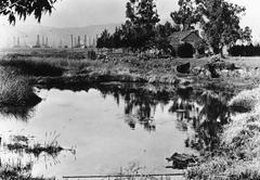 La Brea Tar Pits and Hancock ranch house with oil wells, 1910