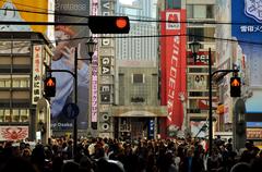 Vibrant night view of Dotonbori in Osaka with illuminated billboards reflecting on the river