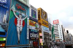 Dotonbori, Osaka at night with neon lights and billboards reflecting on the canal