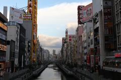 Dotonbori at night with bright neon lights and reflections in Osaka, Japan