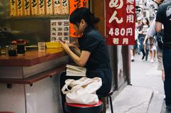 Omoide Yokocho at night with illuminated lanterns and people