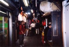 Shinjuku Omoide Yokocho at night with illuminated signs and narrow alley