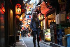 Annette White walking through Piss Alley in Tokyo, Japan