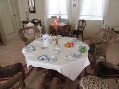 Birthday table set with white tablecloth, Dannebrog flags, and Tranquebar dinnerware in the main hall