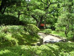 Kyu-Yasuda teien garden view with pond, trees, and traditional Japanese elements