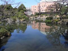 Kyu Yasuda Garden view with traditional style bridge over a pond