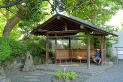 Old Yasuda Garden pond with traditional Japanese bridge and lush greenery