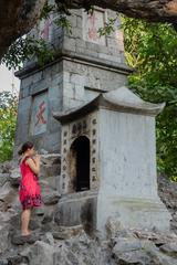 Vietnamese woman bringing offerings to a shrine at Hoàn Kiếm Lake in Hanoi