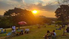 Praça Pôr do Sol at sunset with a silhouette of trees and people enjoying the view