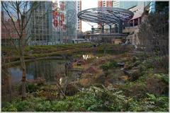 Scenic view of Mori Garden with a pond, traditional Japanese architecture, and lush greenery