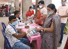 Polling official administering indelible ink to a voter at Bihar Assembly Election