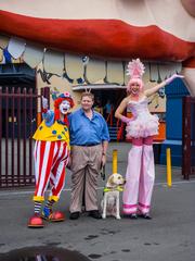 Guide dog sitting with clowns at Luna Park in Milsons Point, Sydney