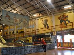 Interior of Coney Island at Luna Park Sydney with slide and murals