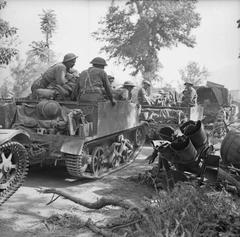 Universal carriers of 1st Royal Irish Fusiliers pass a wrecked German Nebelwerfer near Ceprano, May 1944