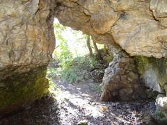 Jaskinia Twardowskiego cave entrance with rocky surroundings