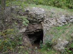 Interior of Jaskinia Twardowskiego cave with rocky walls and scattered light