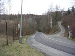 Road in Prague with fields and buildings in the background